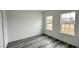 Bright bedroom with two windows and grey vinyl flooring at 14511 Sw 29Th Ter, Ocala, FL 34473