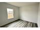 Simple bedroom with a window and grey vinyl flooring at 14511 Sw 29Th Ter, Ocala, FL 34473