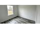 Well-lit bedroom featuring a large window and grey vinyl flooring at 14511 Sw 29Th Ter, Ocala, FL 34473