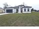 One-story house with gray roof, white walls, and a dark gray garage door at 14511 Sw 29Th Ter, Ocala, FL 34473