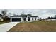 One-story house with gray roof, white walls, and a dark gray garage door at 14511 Sw 29Th Ter, Ocala, FL 34473