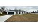 One-story house with gray roof, white walls, and a dark gray garage door at 14511 Sw 29Th Ter, Ocala, FL 34473