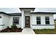 Modern front door with wood accents and sidelights, welcoming entryway at 14511 Sw 29Th Ter, Ocala, FL 34473