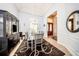 Bright dining room with a glass-top table and dark wood hutch at 1458 Foxtail Dr, Lake Mary, FL 32746