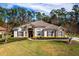 Single-story home with tile roof, stone accents, and lush landscaping at 1458 Foxtail Dr, Lake Mary, FL 32746