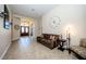 Spacious living room with tile floors and a brown couch at 1458 Foxtail Dr, Lake Mary, FL 32746