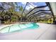 Inviting pool area with screened enclosure, spa, and lounge chairs at 1458 Foxtail Dr, Lake Mary, FL 32746