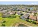 Beautiful aerial view of homes near a lake with mature landscaping and a screened-in pool at 15199 Sugargrove Way, Orlando, FL 32828