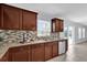 Elegant kitchen with dark wood cabinets and a view of the backyard at 15199 Sugargrove Way, Orlando, FL 32828