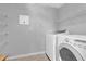 Bright laundry room with a full-size washer, dryer, and ample shelving for storage at 15199 Sugargrove Way, Orlando, FL 32828