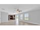 Open concept living room flowing into a kitchen with dark wood cabinets and a sliding glass door at 15199 Sugargrove Way, Orlando, FL 32828