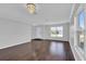 Inviting living room features hardwood floors and a large window for natural light at 15199 Sugargrove Way, Orlando, FL 32828