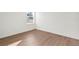 Bedroom featuring wood-look flooring, a large window and electrical outlets on the wall at 1719 Sw 166Th St, Ocala, FL 34473