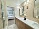 Bright bathroom with double vanity and view of bedroom at 1933 Winnebago Trl, Fern Park, FL 32730