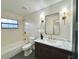 Modern bathroom boasts marble vanity, hexagon tile, and gold fixtures at 1933 Winnebago Trl, Fern Park, FL 32730