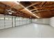 Large garage with high ceilings, white walls, and three garage doors at 1933 Winnebago Trl, Fern Park, FL 32730