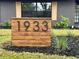 Modern house number sign on a stained wood base at 1933 Winnebago Trl, Fern Park, FL 32730