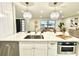 Modern kitchen island with sink, quartz countertops and built in microwave at 1933 Winnebago Trl, Fern Park, FL 32730