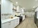 Modern kitchen with white cabinets and marble backsplash at 1933 Winnebago Trl, Fern Park, FL 32730