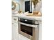 Stainless steel microwave built into white shaker cabinets at 1933 Winnebago Trl, Fern Park, FL 32730