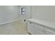 Bright laundry room with white cabinets and geometric tile floor at 1933 Winnebago Trl, Fern Park, FL 32730