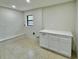 Laundry room features white cabinets, geometric tile, and built-in bench at 1933 Winnebago Trl, Fern Park, FL 32730