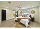 Spacious bedroom with king-size bed and sliding barn door at 1933 Winnebago Trl, Fern Park, FL 32730