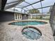 Relaxing kidney-shaped pool with spa and covered patio at 1933 Winnebago Trl, Fern Park, FL 32730