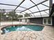 Inviting kidney-shaped pool and spa with covered patio at 1933 Winnebago Trl, Fern Park, FL 32730