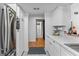 White kitchen with marble countertops and stainless steel refrigerator at 194 Post Way, Casselberry, FL 32707