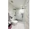 Bathroom with marble-look walls, shower, and toilet at 209 San Carlo Rd, Davenport, FL 33896