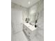 Bathroom with marble-look walls and modern vanity at 209 San Carlo Rd, Davenport, FL 33896