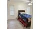 Bedroom with double door closet and wood-look flooring at 209 San Carlo Rd, Davenport, FL 33896