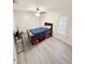 Bedroom with double door closet and wood-look flooring at 209 San Carlo Rd, Davenport, FL 33896