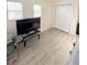 Bedroom with wood-look flooring and large TV at 209 San Carlo Rd, Davenport, FL 33896