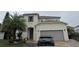 Two-story house with attached garage and landscaping at 209 San Carlo Rd, Davenport, FL 33896