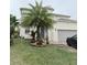 Two-story house with palm tree and landscaping at 209 San Carlo Rd, Davenport, FL 33896