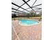 Inviting screened pool with brick pavers and a spa at 209 San Carlo Rd, Davenport, FL 33896