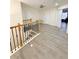 Bright upper hallway with wood-look flooring and stairs at 209 San Carlo Rd, Davenport, FL 33896