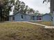 Newly built home with a large backyard, deck, and detached shed at 2104 Newman St, Orlando, FL 32803