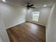 Bright bedroom with wood-look floors and ceiling fan at 2104 Newman St, Orlando, FL 32803