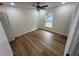 Bright bedroom with wood-look flooring and a ceiling fan at 2104 Newman St, Orlando, FL 32803