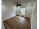 Bright bedroom with wood-look floors and ceiling fan at 2104 Newman St, Orlando, FL 32803