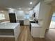 Modern kitchen with white cabinets, quartz countertops, and stainless steel appliances at 2104 Newman St, Orlando, FL 32803