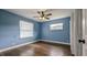 Bedroom with hardwood floors, ceiling fan, and window at 2405 Se 157Th Lane Rd, Summerfield, FL 34491