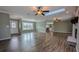 Spacious living room featuring hardwood floors, recessed lighting, and a view into the kitchen at 2405 Se 157Th Lane Rd, Summerfield, FL 34491