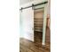 Modern pantry with sliding barn door and wire shelving for efficient storage at 2405 Se 157Th Lane Rd, Summerfield, FL 34491