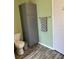 Bathroom with toilet and gray storage cabinet at 250 Joanne Dr, Davenport, FL 33897