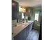 Modern bathroom with gray cabinets and granite countertop at 250 Joanne Dr, Davenport, FL 33897