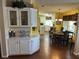 Kitchen and dining area with wood floors, white cabinets, and a round table at 250 Joanne Dr, Davenport, FL 33897